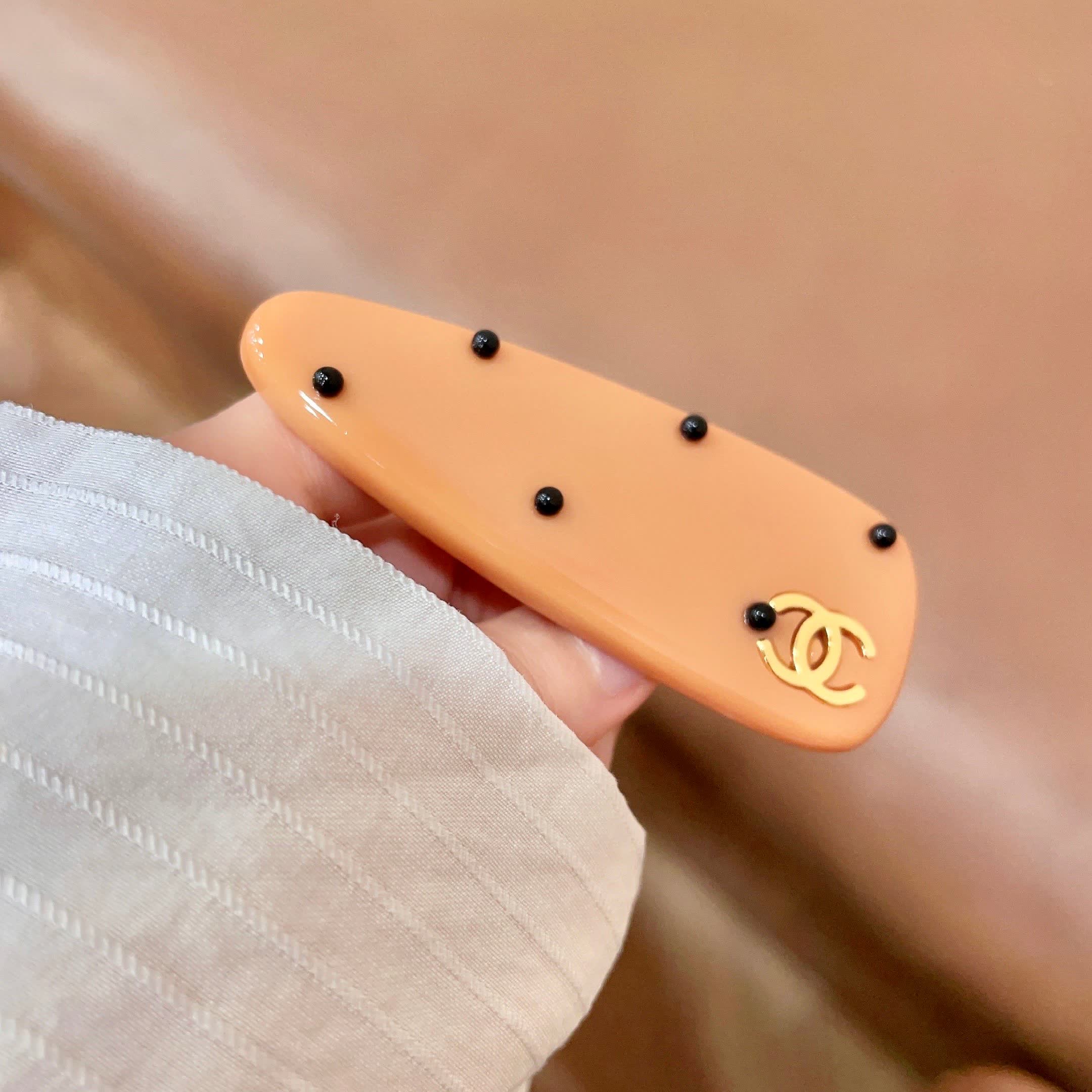 Chanel Orange Hair Clip with Black Dots